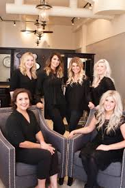  The salon team posing together, showcasing their expertise and professionalism in a stylish salon setting.