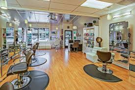 A salon with chairs and mirrors in the middle of the room.