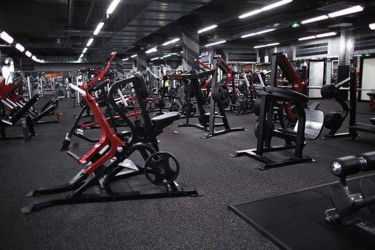 “Modern gym interior with strength training equipment and machines.”